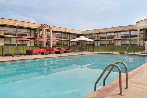 a swimming pool in front of a hotel at Baymont by Wyndham Culpeper in Culpeper