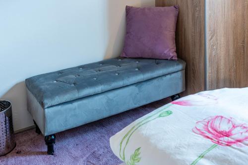a couch in a room with a pillow and a bed at Haus Sonnengarten-Lienz in Lienz