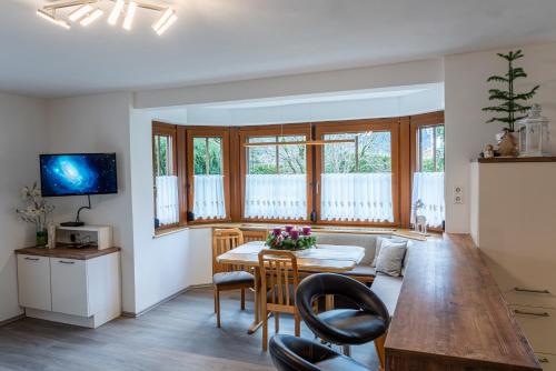 a kitchen and living room with a table and chairs at Haus Sonnengarten-Lienz in Lienz