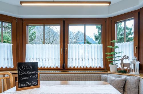 a living room with windows with white curtains at Haus Sonnengarten-Lienz in Lienz