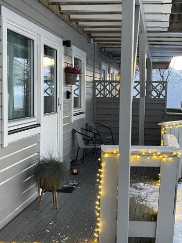 a porch with string lights on a house at Appartment close to the city, ocean and mountains -Tromsø in Tromsø