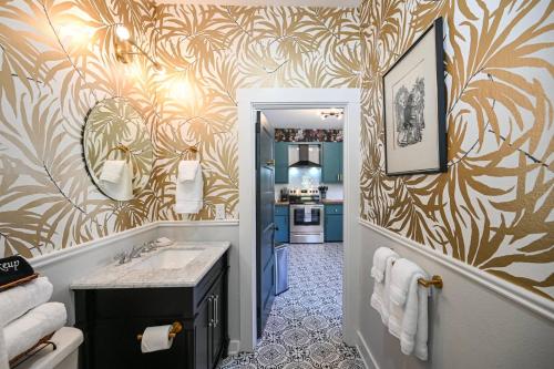 a bathroom with a sink and a hallway with a kitchen at Sweet Carolina by AvantStay Near Black Mountain in Swannanoa