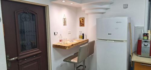 a kitchen with a counter and a refrigerator at RutSuite in Afula