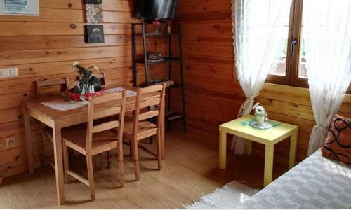 a room with a table and chairs and a bedroom at Cabañas Caudiel in Caudiel
