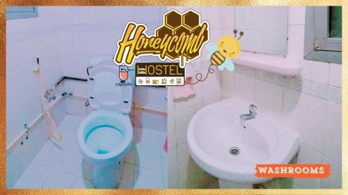 a bathroom with a toilet and a sink at Honeycomb Capsule Hostel Near Burjuman and Sharaf dg metro in Dubai