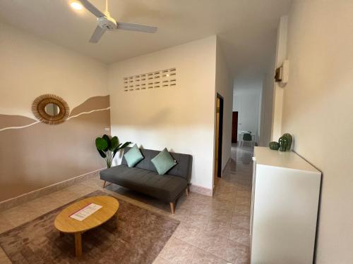 a living room with a couch and a table at Casa Cactus in Bangrak Beach