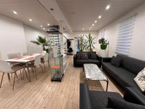 a living room with a couch and a table and chairs at Gästehaus pack of patches in Jena