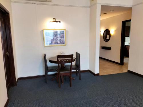 a dining room with a table and chairs at Bukit Bintang Suite at Times Square KL in Kuala Lumpur