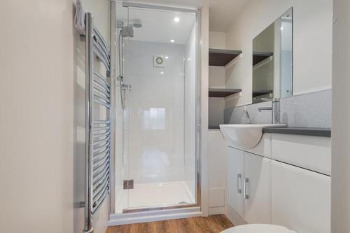 a white bathroom with a shower and a sink at 2 Bed in Eden Valley SZ209 in Kirkoswald