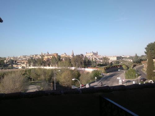 a view of a street with a city in the background at Hotel Los Cigarrales in Toledo