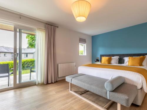 a bedroom with a large bed and a large window at 2 Bed in St. Mellion 87712 in St Mellion