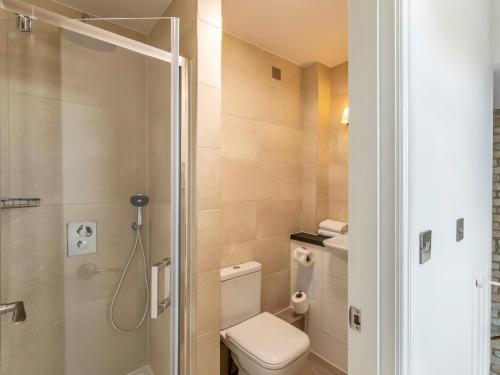 a small bathroom with a toilet and a shower at 2 Bed in St. Mellion 87712 in St Mellion