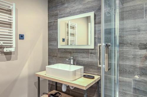 a bathroom with a sink and a shower at VIP apart 703 in Tbilisi City