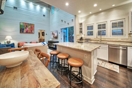 a kitchen with a counter and some stools at 16 Palms by AvantStay Luxury Pool Playscape in Port Aransas