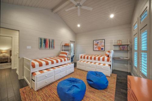 a bedroom with two beds and two ottomans at 16 Palms by AvantStay Luxury Pool Playscape in Port Aransas