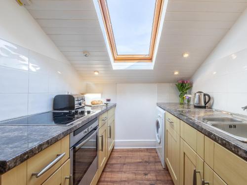 a kitchen with a sink and a skylight at 2 Bed in Croyde 87110 in Croyde