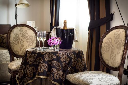a table with a table cloth and flowers on it at Antica Stazione in Chiaramonte Gulfi