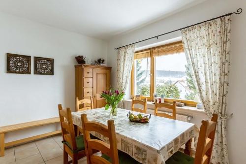 a dining room with a table and chairs and a window at Landhaus am Diemelsee in Diemelsee