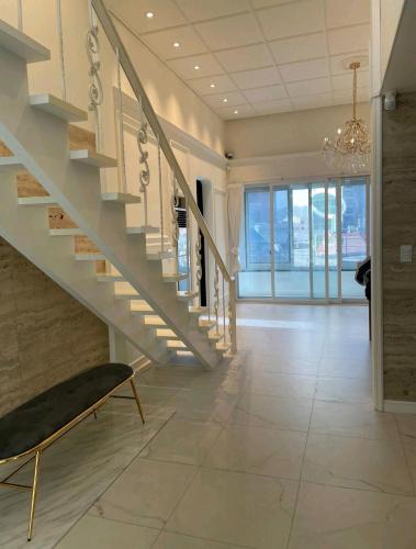 a hallway with a staircase and a chair in a building at y park in Seoul