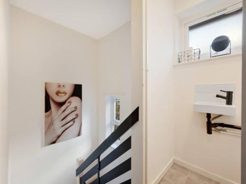 a bathroom with a picture of a woman on the wall at Pass the Keys 3 bedroom modern house in Withington in Manchester