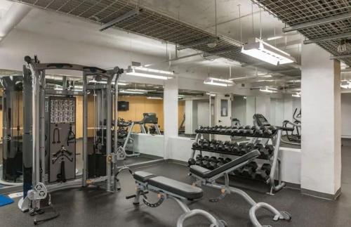 a gym with a lot of equipment in a room at Beautiful 2BR2BA in Bldg connected to Skywalk in Des Moines