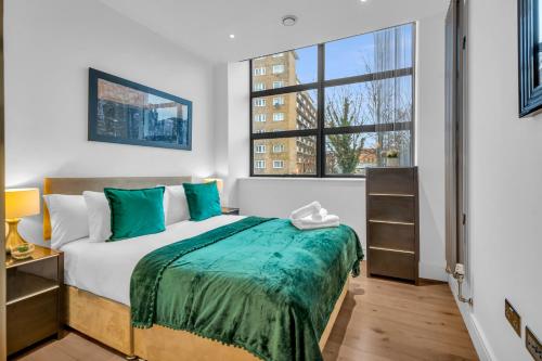 - une chambre avec un lit et une grande fenêtre dans l'établissement Regent's Park Serviced Apartments by MySquare, à Londres