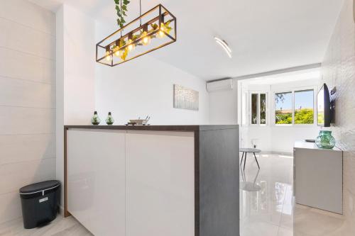 a kitchen with a counter and a sink in a room at Espanatour MENORCA in Dehesa de Campoamor