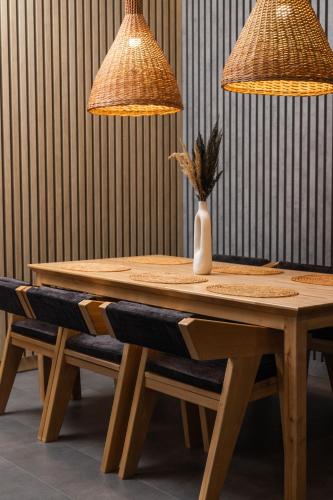 a wooden table with two lamps and a vase on it at Black & White Villas by Fomich Hotels Group in Bukovel