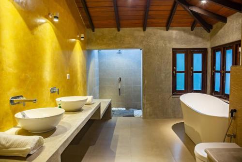 a bathroom with two sinks and a tub at Villa Milla Walauwa in Matale
