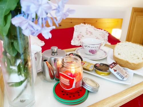 a table with a jar of fruit and a plate of bread at Villa Mar Vintage Apartments in Dubrovnik