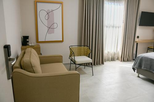 Uma televisão e/ou sistema de entretenimento em Hotel Amor de Mae