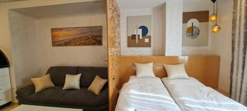 a bedroom with a bed and a couch at Résidence avec piscine Agadir in Agadir