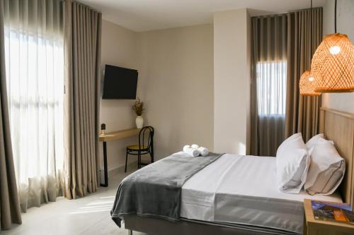 Uma cama ou camas num quarto em Hotel Amor de Mae