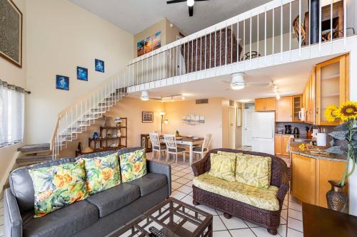 a living room with a couch and a table at Kona Alii 512 in Kailua-Kona