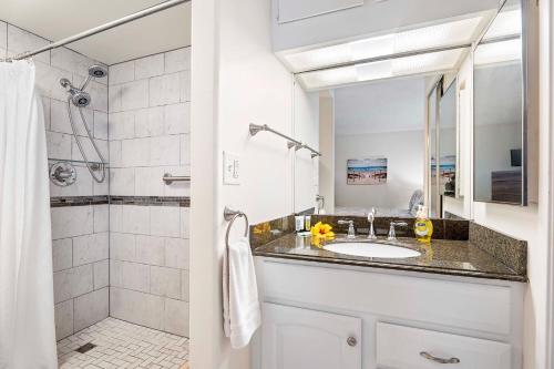 a bathroom with a sink and a shower at Kona Alii 512 in Kailua-Kona