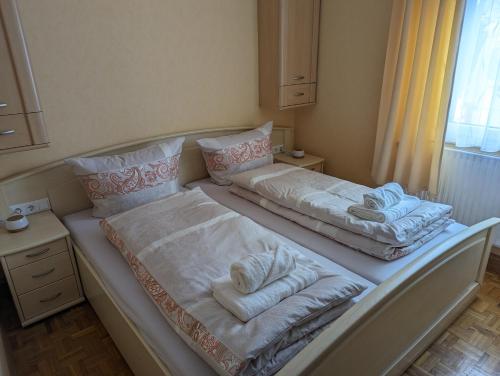 een groot bed met handdoeken in een kamer bij Ferienhaus Waldblick im Erzgebirge in Jahnsdorf
