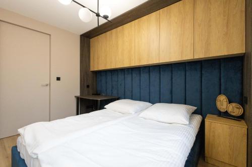 מיטה או מיטות בחדר ב-Apartament Mieszko
