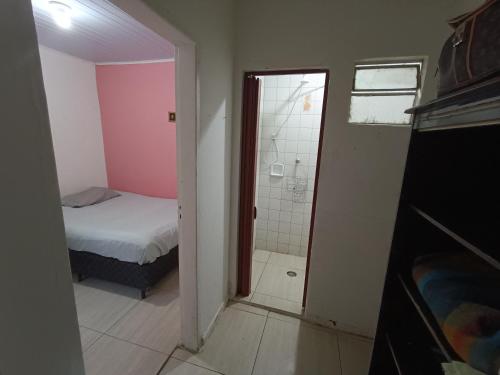 a bedroom with a bed and a shower and a mirror at Vila Olímpia - Econômica in Sao Paulo