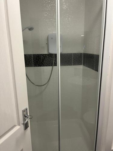 a shower with a glass door in a bathroom at beautiful 2 bedrooms flat for family in Portsmouth