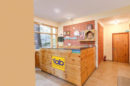 a kitchen with a wooden counter in a room at White Water Inn Mcleodganj in Dharamshala