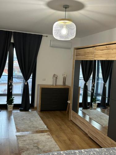 a living room with a large mirror and black curtains at Regim hotelier - AP2camCentral in Craiova
