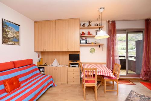 a bedroom with a bed and a table and chairs at Artesina sulle piste in Sella della Turra