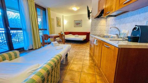 a kitchen with a bed and a sink in a room at Appartamento Smith Moscato - Affitti Brevi Italia in Bardonecchia