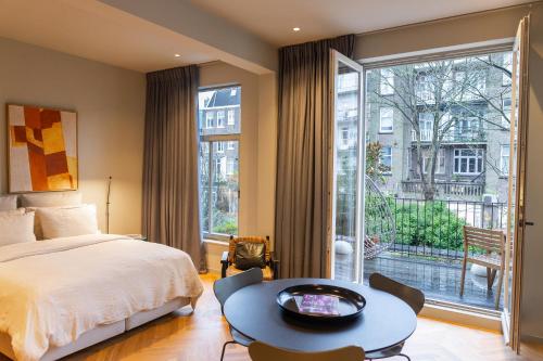 a bedroom with a bed and a large window at Vondel 99 in Amsterdam