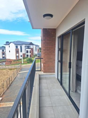 a balcony with a view of a house at Coastal Retreats in Ballito