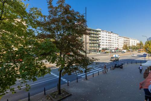 a view of a city street with a tree at Comfortable and Modern Orange Studio in Warsaw by Renters in Warsaw