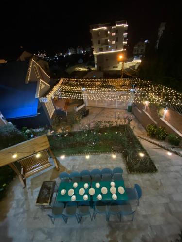 an overhead view of a table and chairs at night at Trà My Villa Đà Lạt BBQ Garden in Da Lat