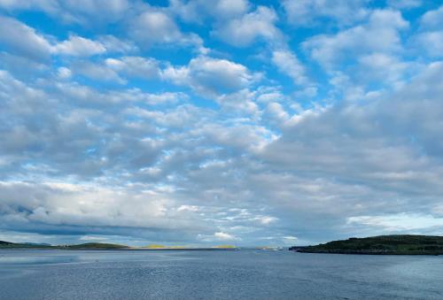 a large body of water under a cloudy sky at Stone fronted detached cottage just over 2 miles from Mulranny village in Mulranny