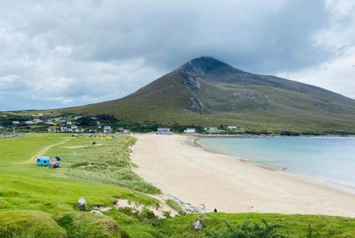 a view of a beach with a mountain in the background at Stone fronted detached cottage just over 2 miles from Mulranny village in Mulranny