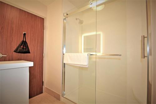 a shower with a glass door in a bathroom at Holiday Inn Express & Suites Ocala by IHG in Ocala